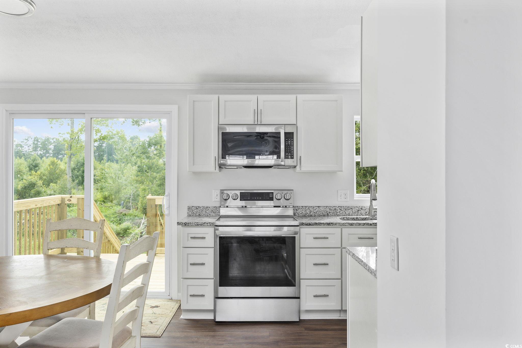 301 Duck Cove Road Conway, SC 29526 - Photo 13 of 25 Dining area featuring a fireplace, dark hardwood /