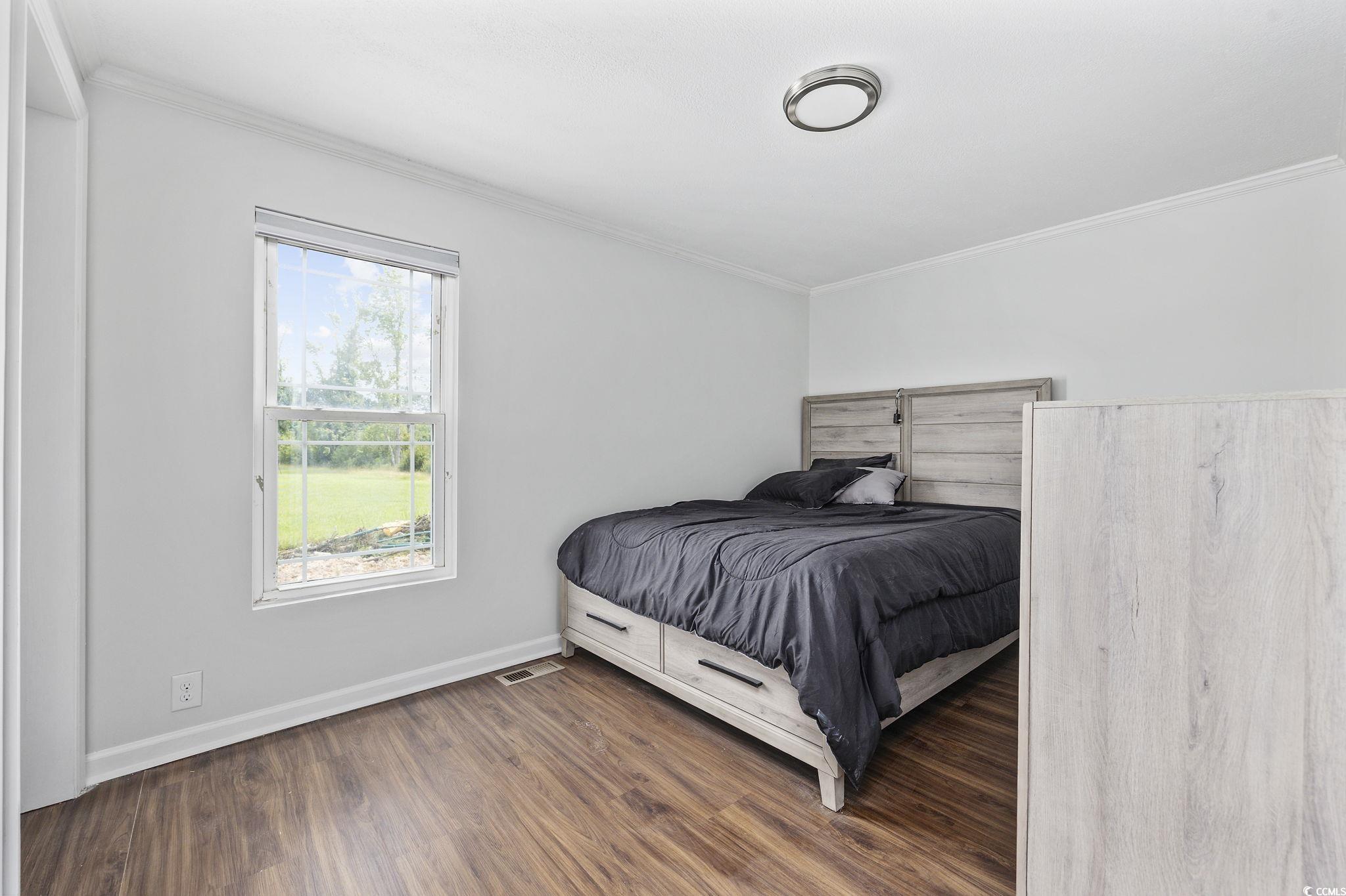 301 Duck Cove Road Conway, SC 29526 - Photo 23 of 25 Bedroom featuring crown molding and dark wood-type