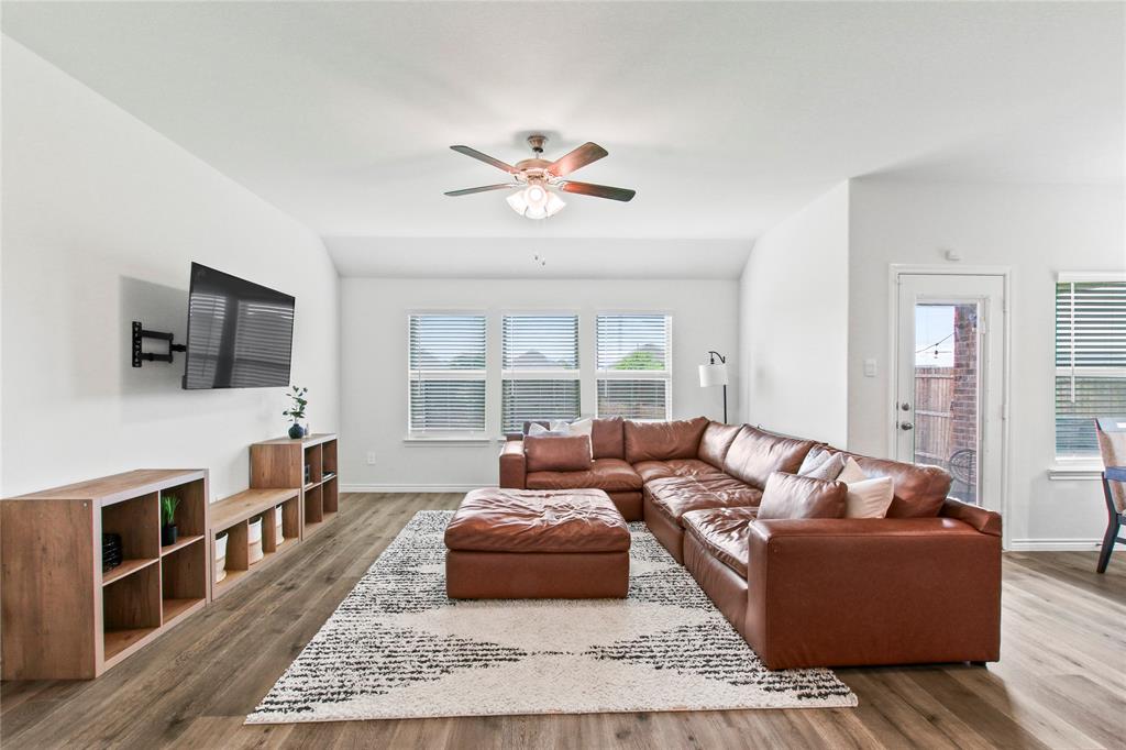 2920 Pinecrest Drive Aubrey, TX 76227 - Photo 11 of 27 a living room with furniture and a flat screen tv