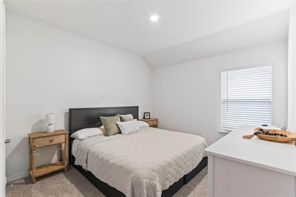 2920 Pinecrest Drive Aubrey, TX 76227 - Photo 14 of 27 a bedroom with a bed and a table