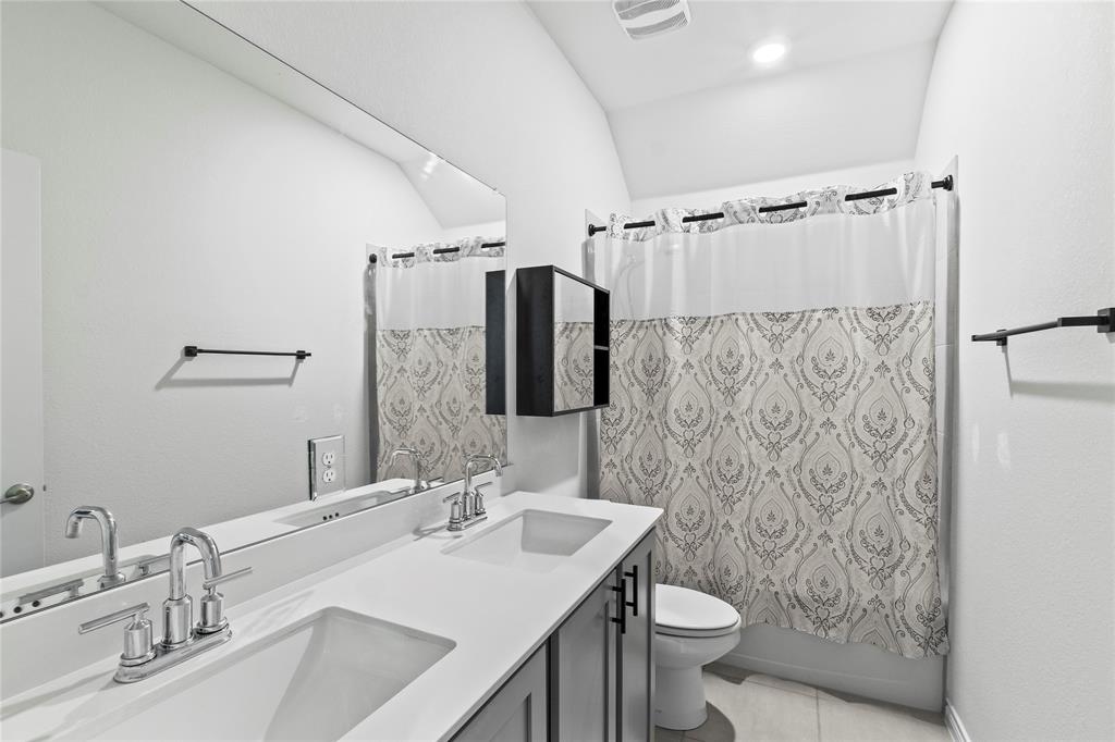 2920 Pinecrest Drive Aubrey, TX 76227 - Photo 15 of 27 a bathroom with a sink toilet and shower