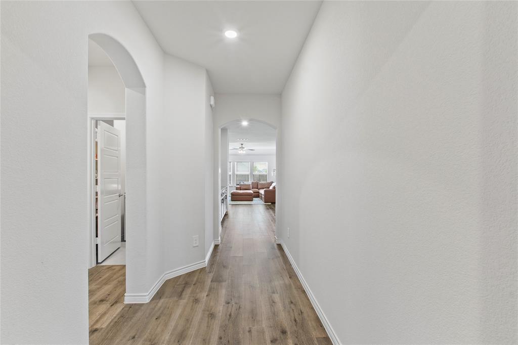 2920 Pinecrest Drive Aubrey, TX 76227 - Photo 2 of 27 a view of a hallway with wooden floor