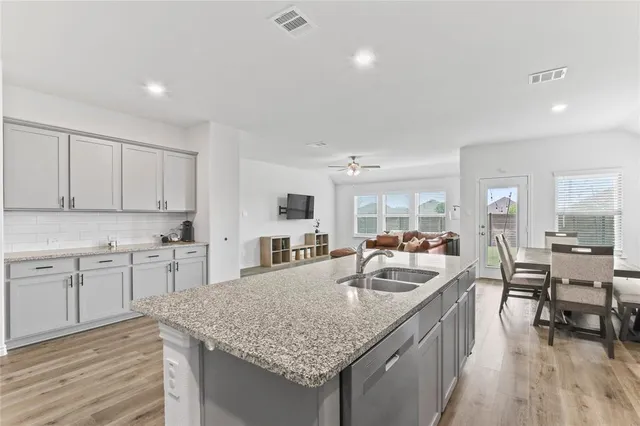 a kitchen with sink stove and cabinets