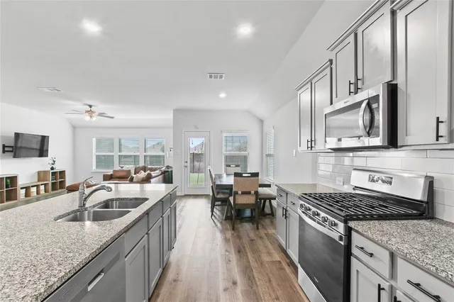 a view of a house with a backyard and porch