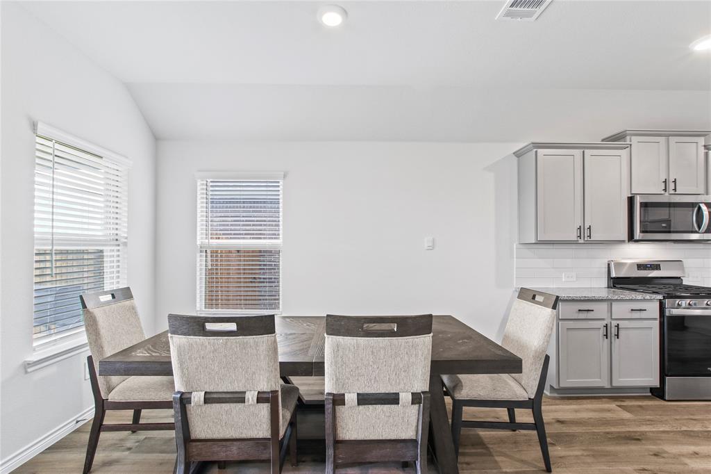 2920 Pinecrest Drive Aubrey, TX 76227 - Photo 7 of 27 a view of a dining room with furniture and wooden floor