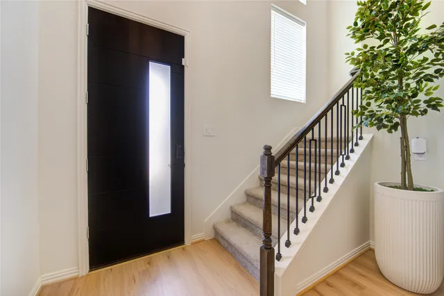 a view of staircase with wooden floor and a potted plant