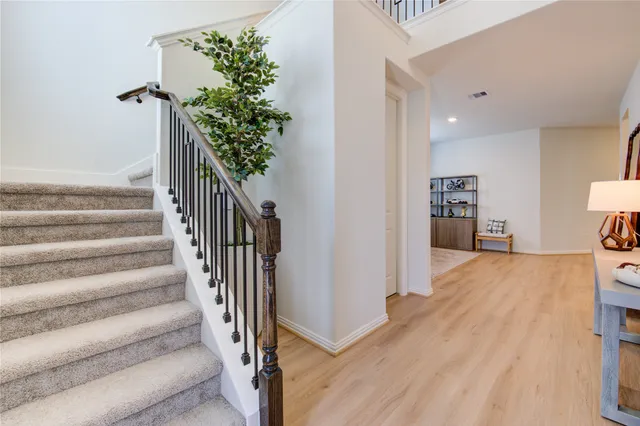 a view of entryway and hall with wooden floor