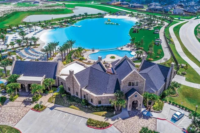 an aerial view of a house with a swimming pool outdoor seating and yard