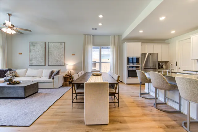 a kitchen with stainless steel appliances granite countertop sink stove top oven and cabinets