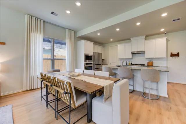 a living room with lots of furniture and kitchen view