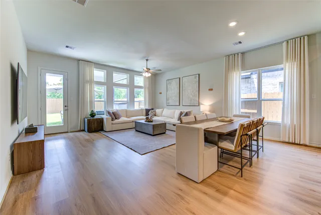 a view of a dining room with furniture and wooden floor