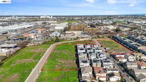 an aerial view of residential houses with outdoor space and river