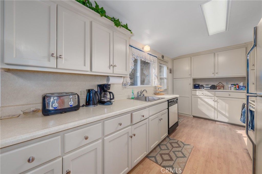 15885 Bottle Rock Road Middletown, CA 95461 - Photo 11 of 38 a kitchen with granite countertop white cabinets and white appliances