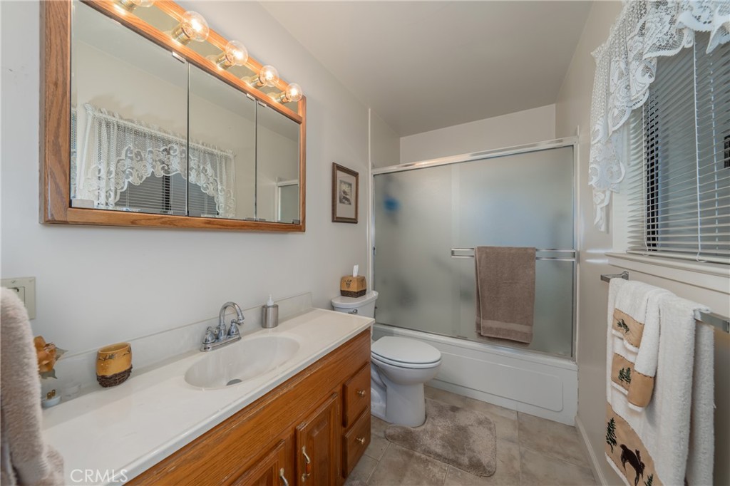 15885 Bottle Rock Road Middletown, CA 95461 - Photo 22 of 38 a bathroom with a double vanity sink mirror and toilet