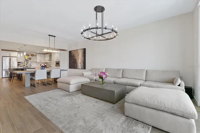 a living room with furniture and a chandelier
