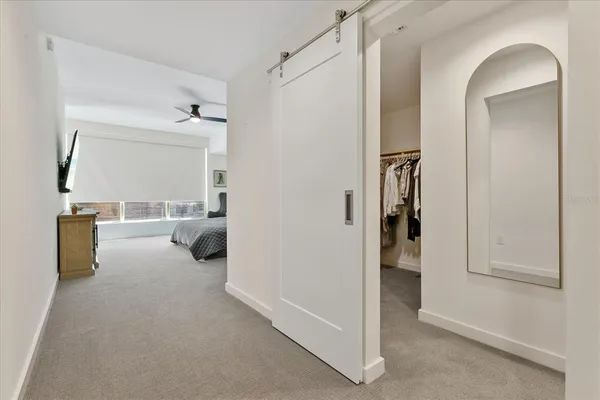 a view of a room that has a bed and a mirror