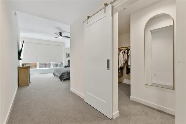 a view of a room that has a bed and a mirror