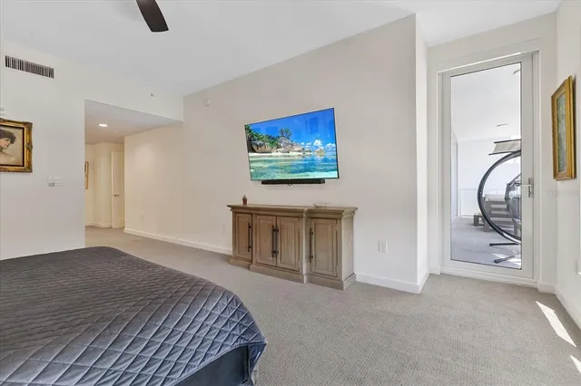 a bedroom with a bed and a painting on the wall