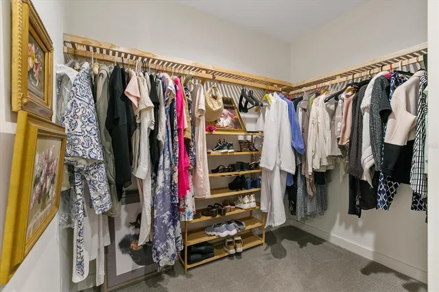 a view of walk in closet with clothes
