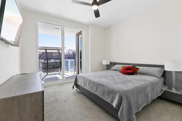 a bedroom with a bed and large window