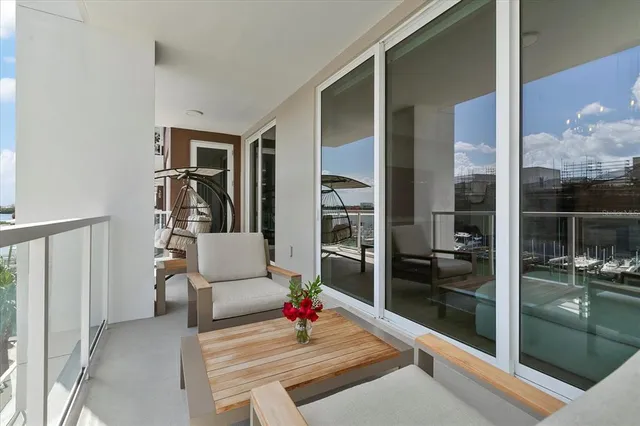 a living room with furniture and a floor to ceiling window