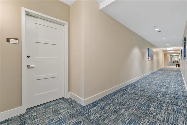 a view of hallway with wooden floor