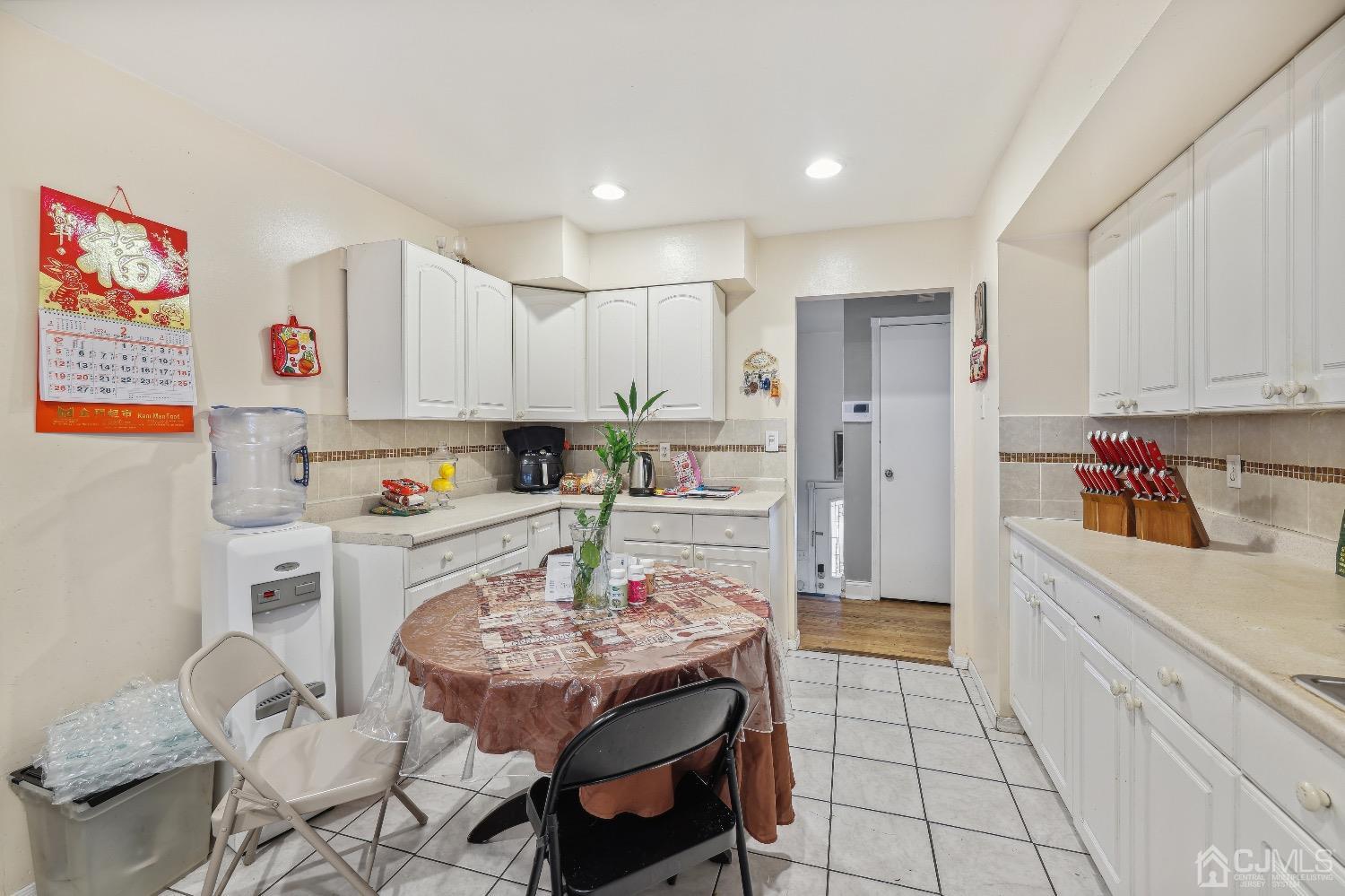 1096 Rudyard Drive Perth Amboy, NJ 08861 - Photo 4 of 10 a kitchen with stainless steel appliances kitchen island granite countertop a refrigerator and cabinets