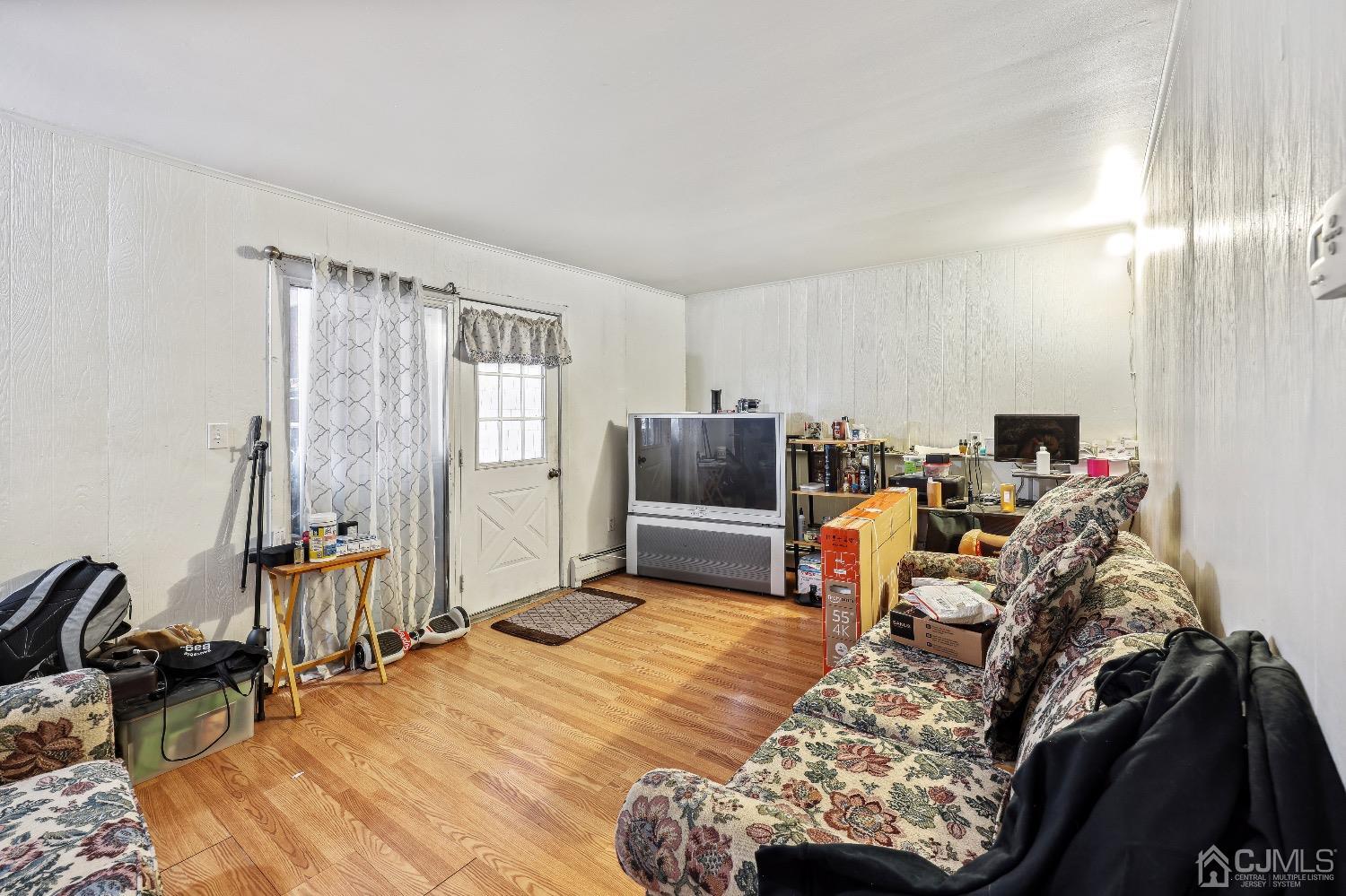 1096 Rudyard Drive Perth Amboy, NJ 08861 - Photo 8 of 10 a bed room with a bed and a chair