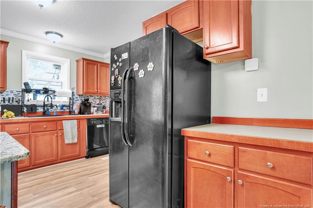 8155 Arabia Road Lumber Bridge, NC 28357 - Photo 13 of 30 a kitchen with stainless steel appliances granite countertop a refrigerator and a sink
