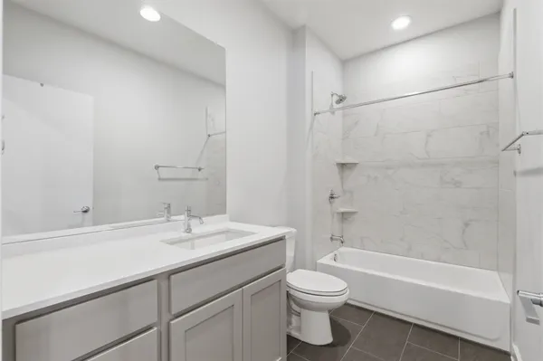 a bathroom with a sink a toilet and bathtub