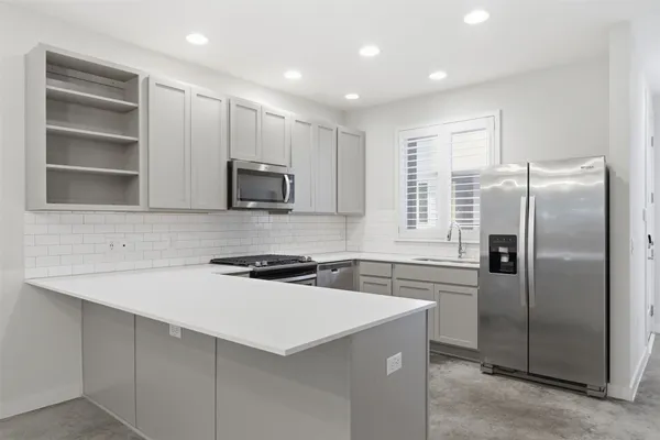 a kitchen with refrigerator cabinets and microwave