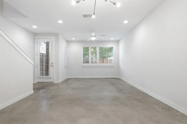 an empty room with windows and closet