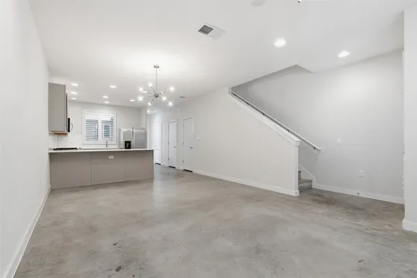 an empty room with kitchen and kitchen view