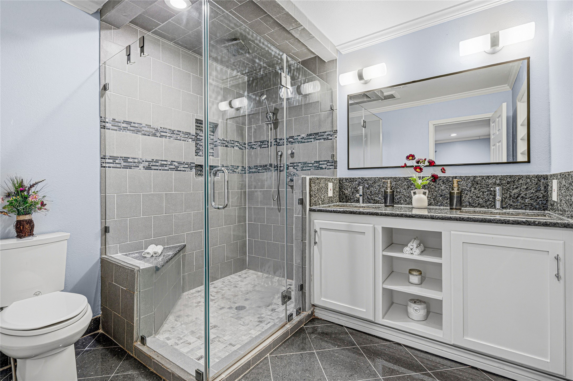 4002 Merrick Street Houston, TX 77025 - Photo 13 of 22 a bathroom with a granite countertop sink a toilet and shower