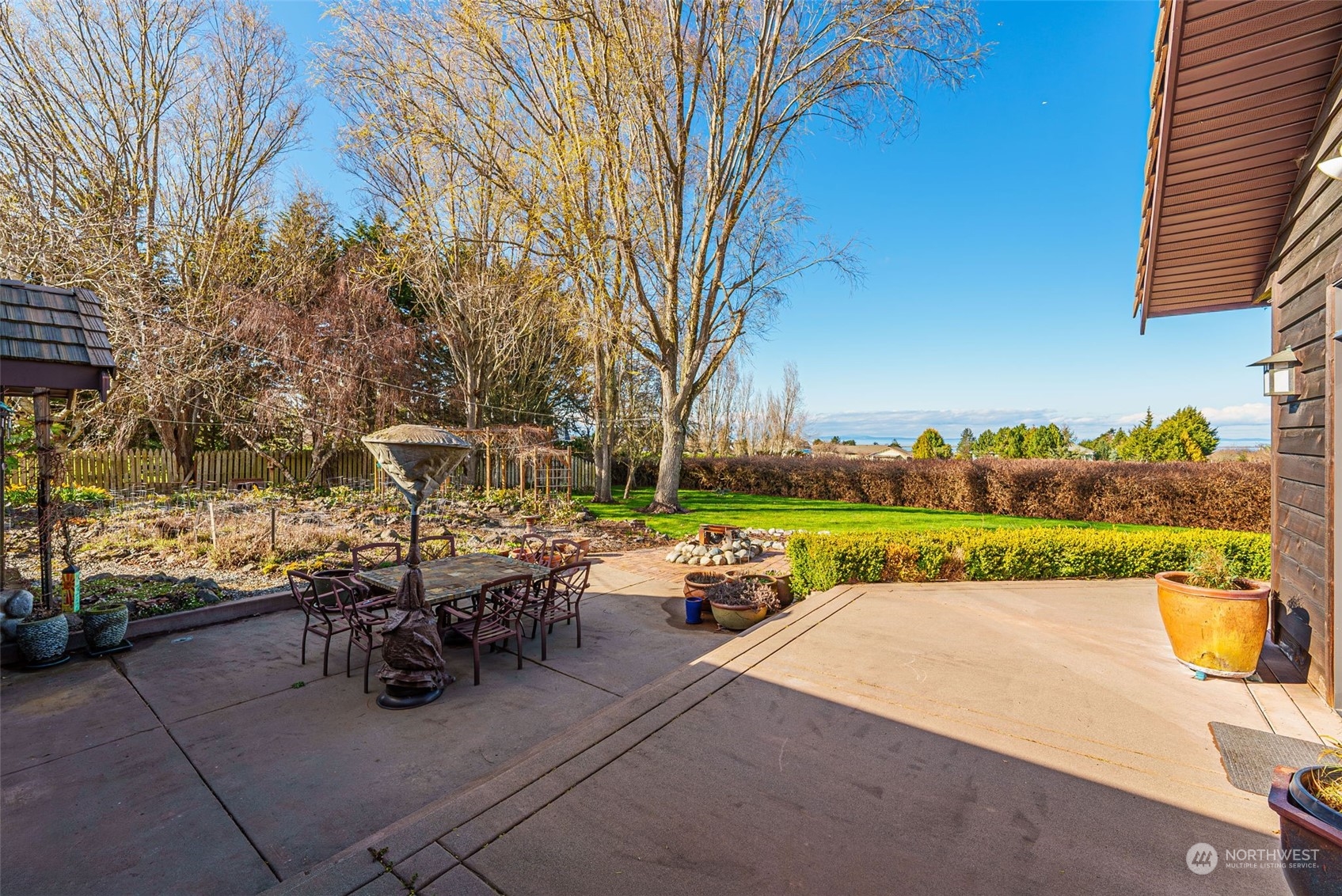 2325 Cays Road Sequim, WA 98382 - Photo 23 of 36 a view of a patio with table and chairs under an umbrella