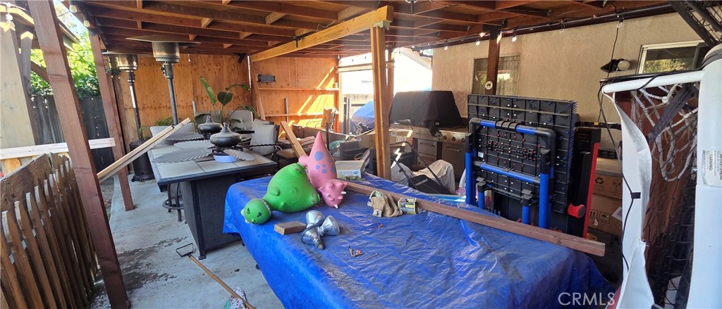 1548 Ranch Road San Bernardino, CA 92407 - Photo 19 of 26 a view of a storage room with furniture toys and wooden floor