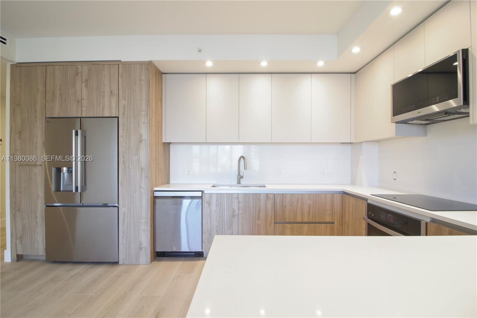 151 Crandon Boulevard, Unit 540 Key Biscayne, FL 33149 - Photo 16 of 41 a kitchen with kitchen island a sink stainless steel appliances and cabinets