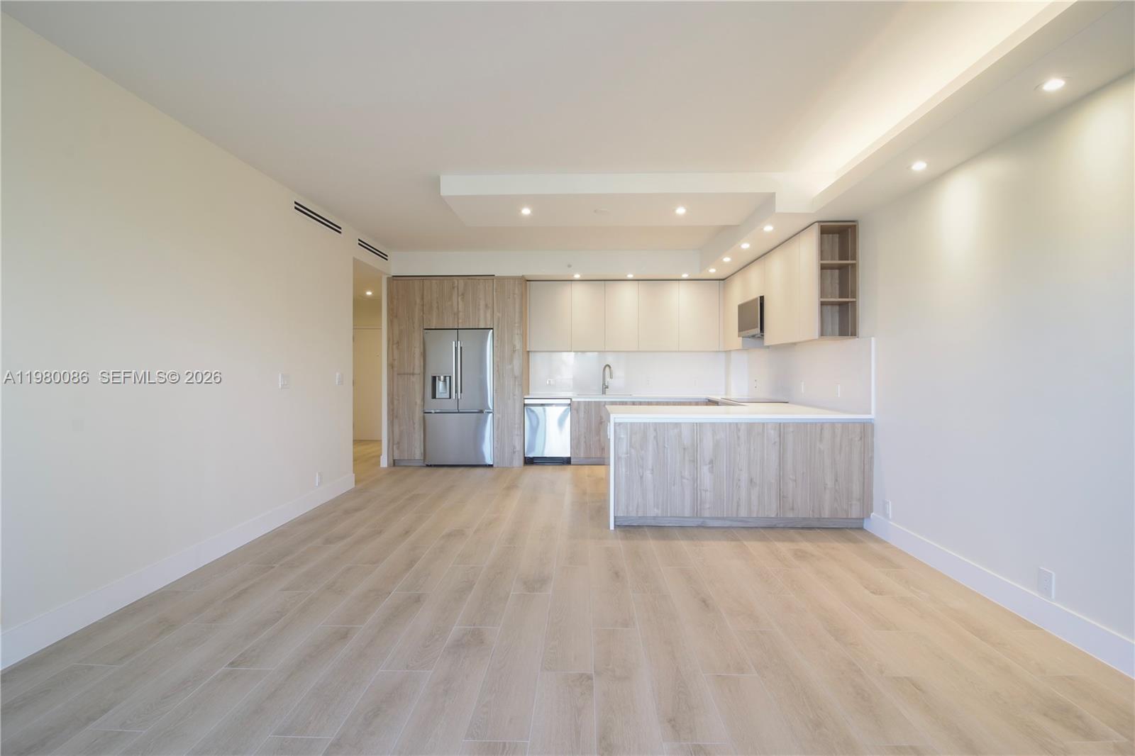 151 Crandon Boulevard, Unit 540 Key Biscayne, FL 33149 - Photo 18 of 41 a view of a kitchen with a sink and wooden cabinets