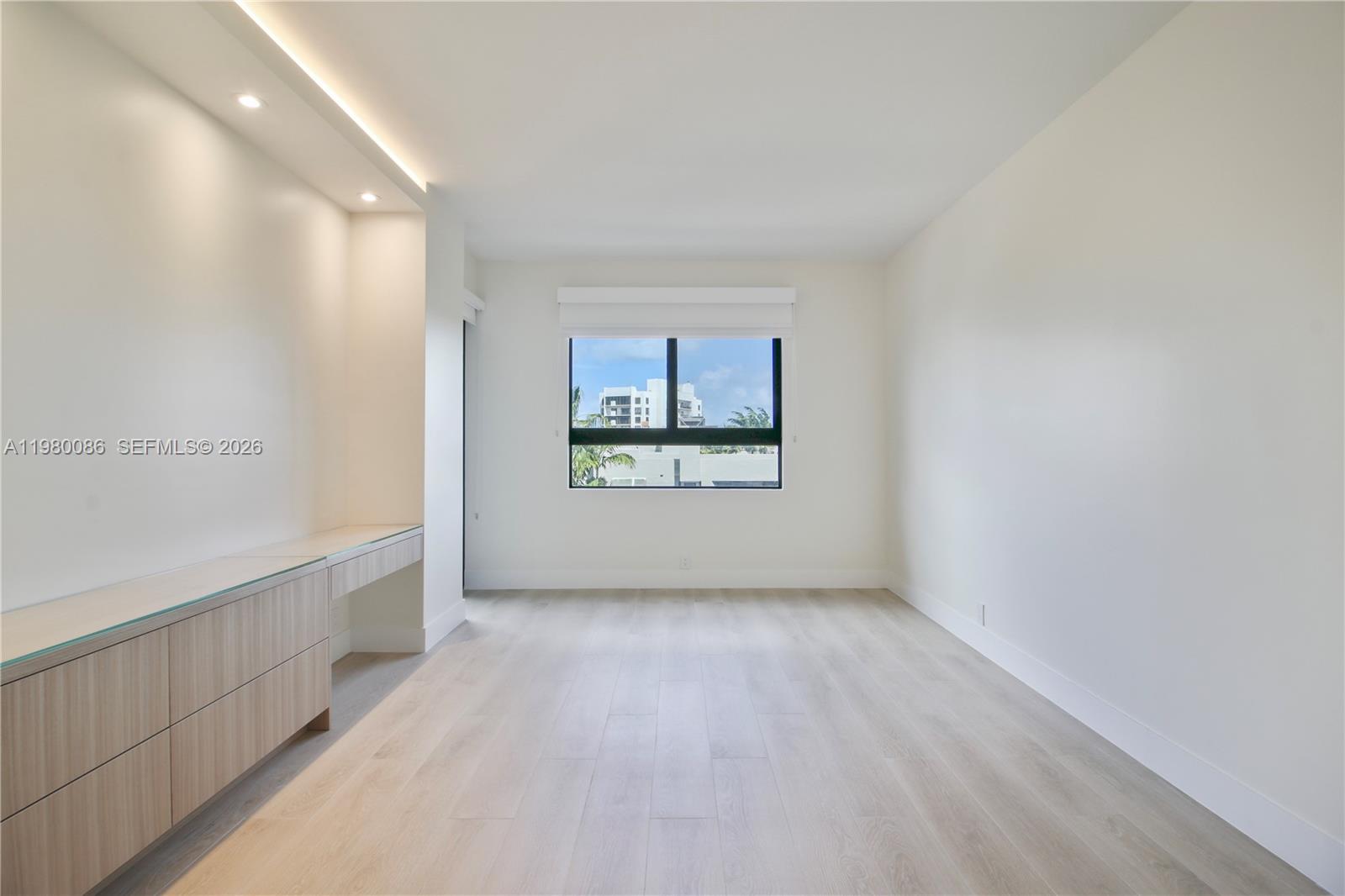 151 Crandon Boulevard, Unit 540 Key Biscayne, FL 33149 - Photo 34 of 41 a view of an empty room with a window and a kitchen