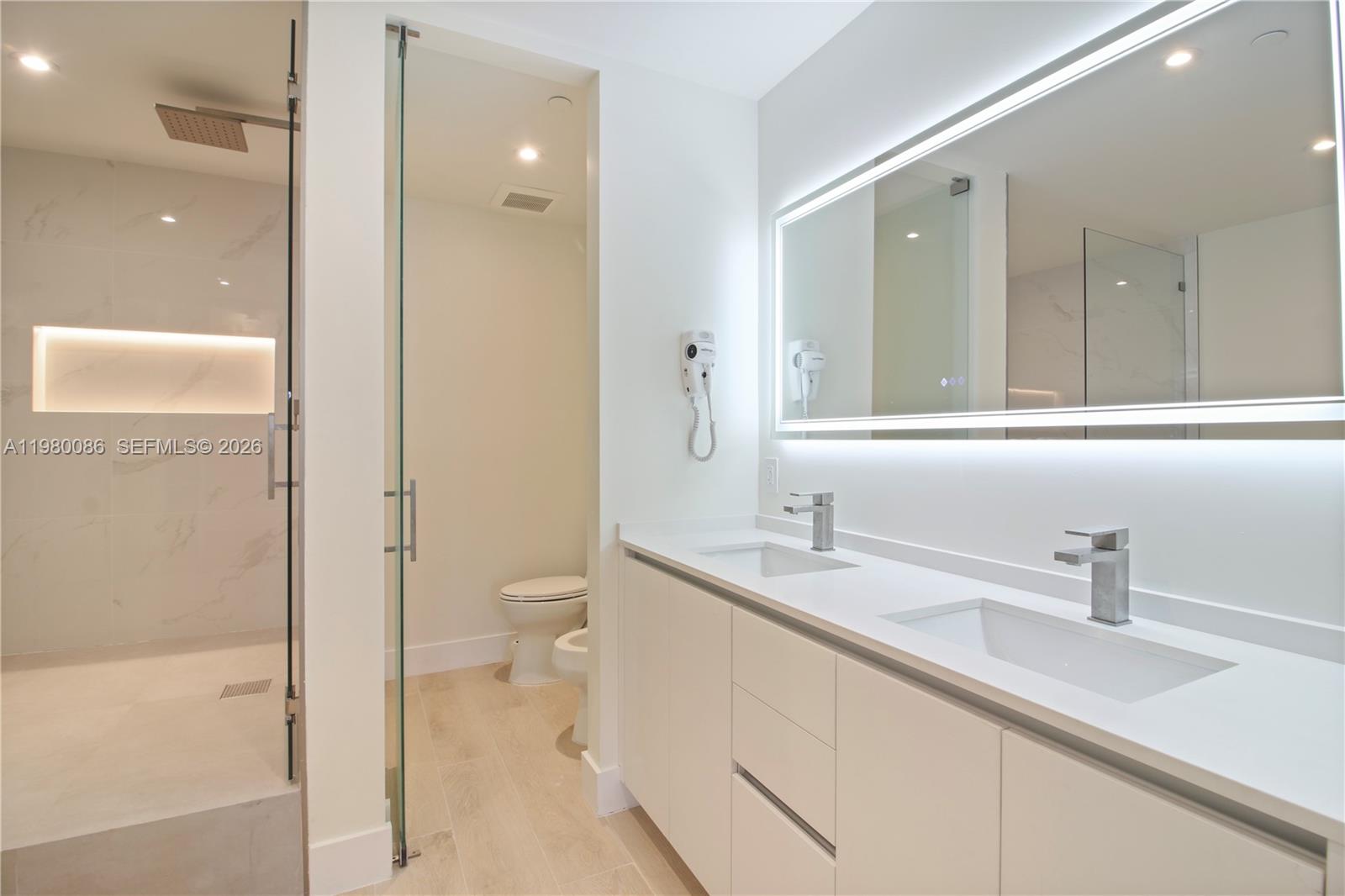 151 Crandon Boulevard, Unit 540 Key Biscayne, FL 33149 - Photo 38 of 41 a bathroom with a sink a toilet and shower