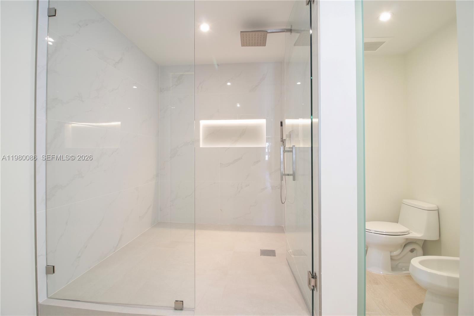 151 Crandon Boulevard, Unit 540 Key Biscayne, FL 33149 - Photo 40 of 41 a bathroom with a shower and a toilet