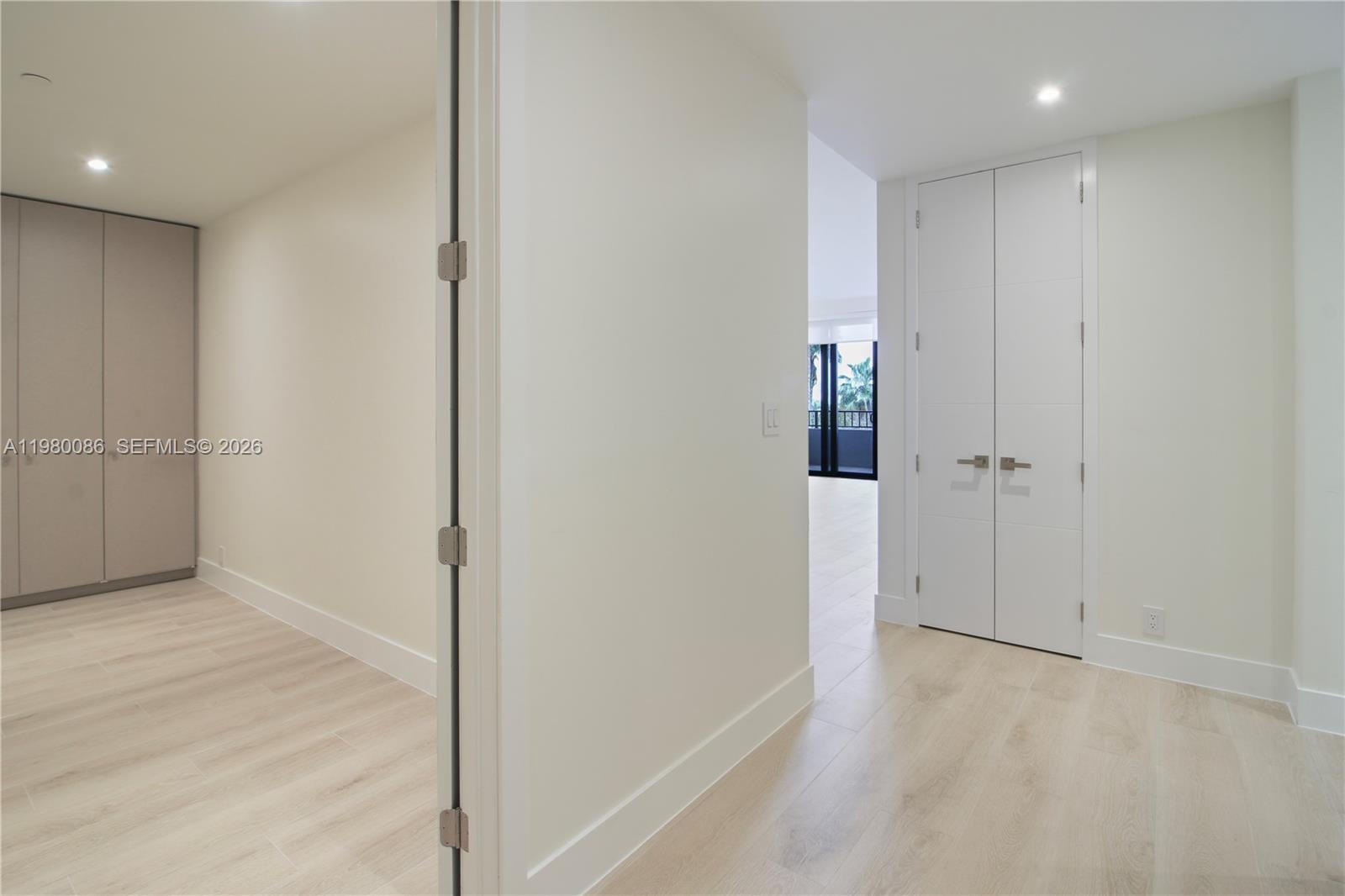 151 Crandon Boulevard, Unit 540 Key Biscayne, FL 33149 - Photo 10 of 41 wooden floor in an empty room with a bathroom