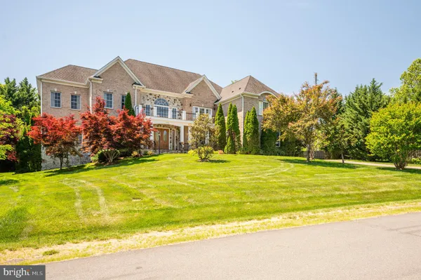 a front view of house with yard and swimming pool
