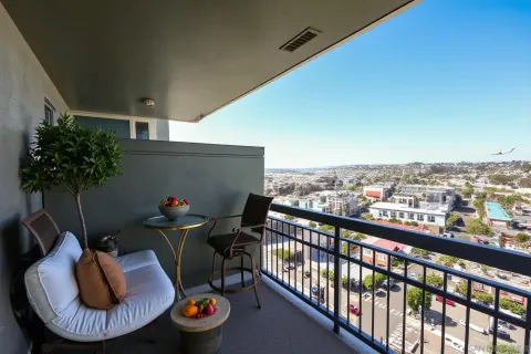 a view of a chairs and table in a balcony