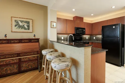 a kitchen with stainless steel appliances granite countertop a refrigerator and a sink