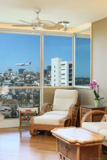 a living room with furniture and a floor to ceiling window