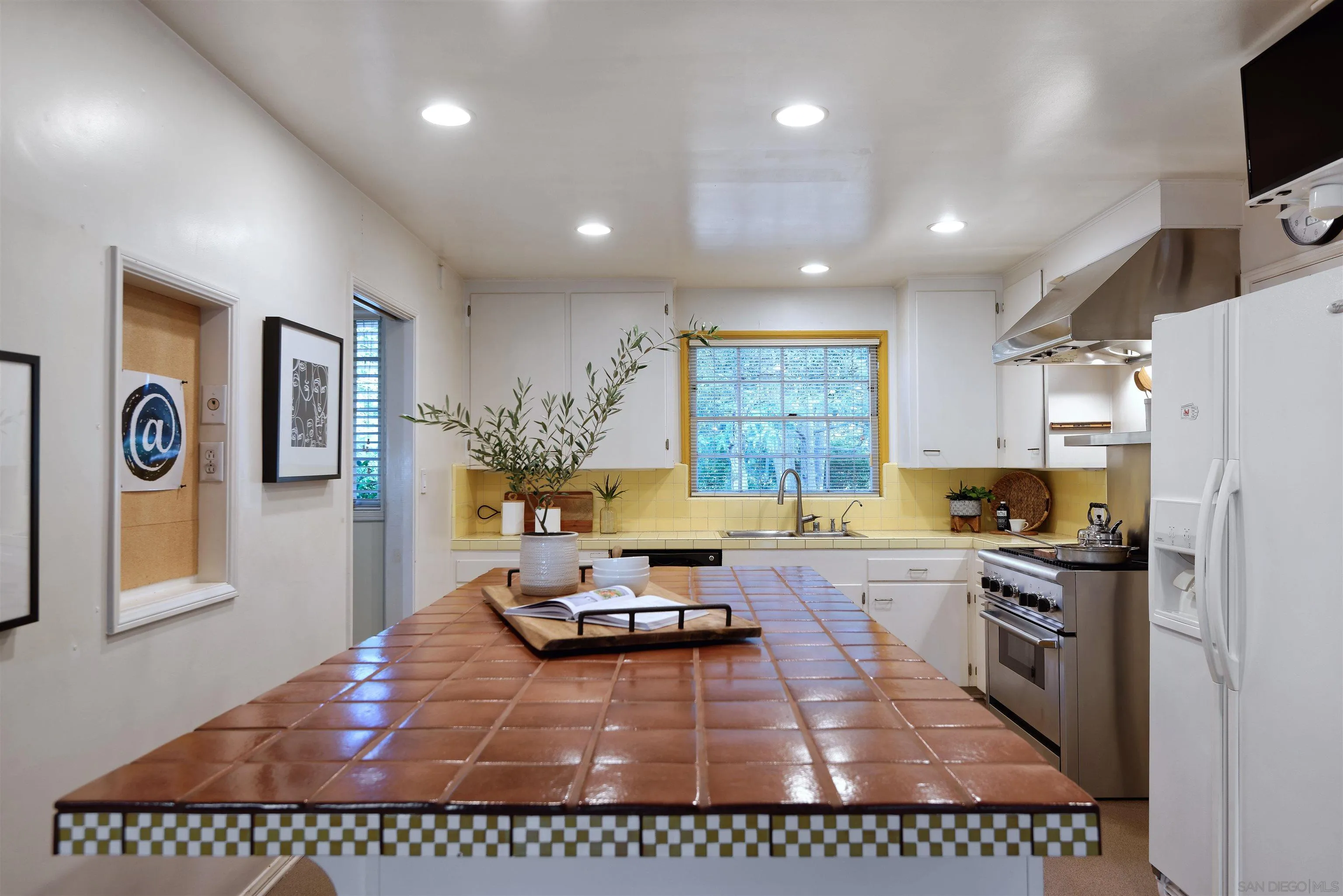 1780 La Jolla Rancho Road La Jolla, CA 92037 - Photo 7 of 24 a kitchen with a refrigerator a stove a microwave a sink and a counter top space