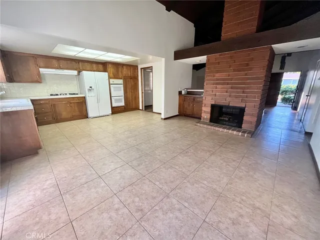 a view of an empty room with a washing machine and stairs