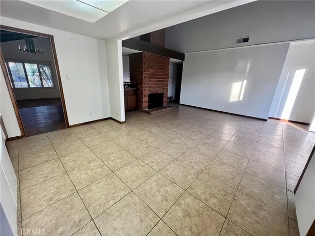a view of a livingroom with furniture and staircase kitchen view