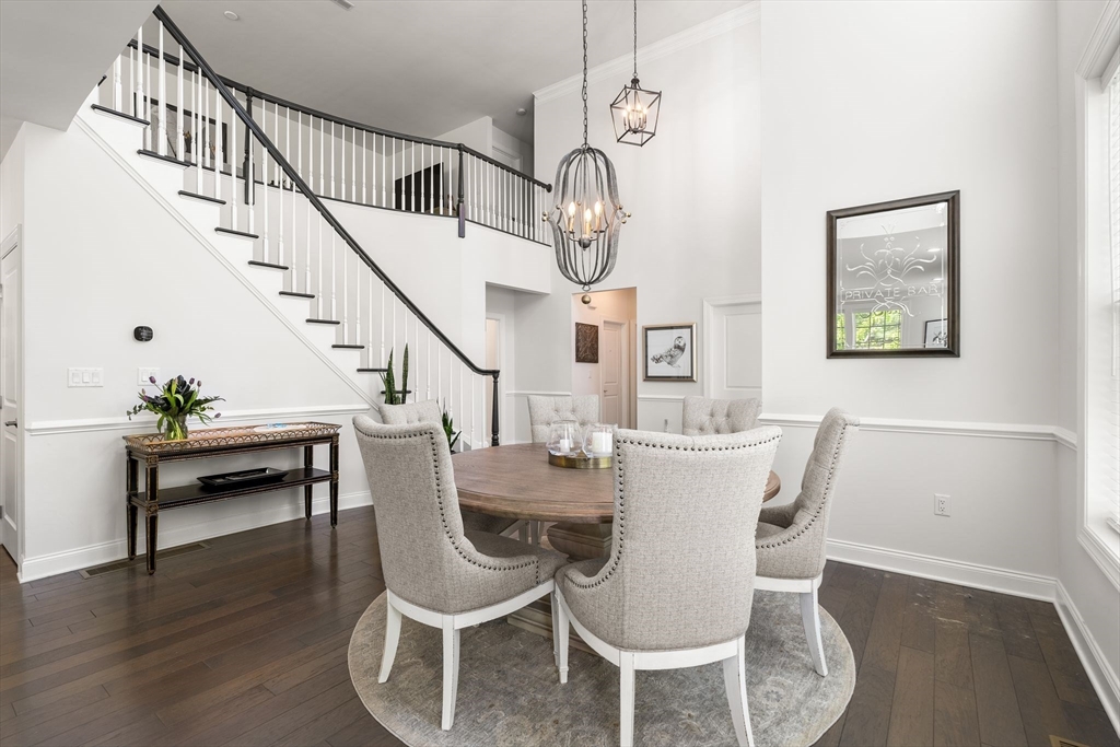 2 Hummingbird Way, Unit 1 Methuen, MA 01844 - Photo 7 of 42 a view of a dining room with furniture wooden floor and a chandelier